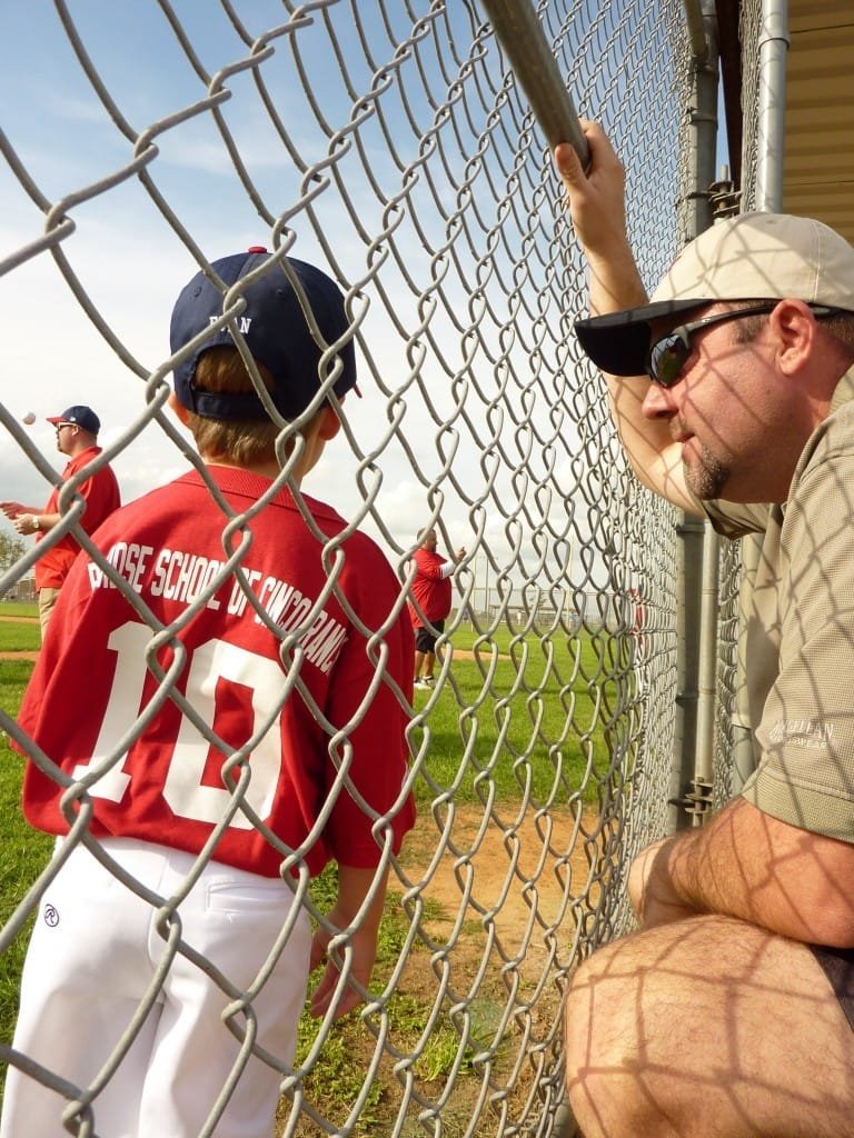 Jeremy watching his son play baseball.