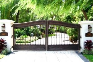 wrought iron gate on a driveway running into a house